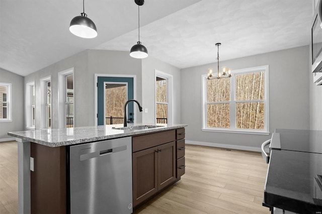 kitchen with hanging light fixtures, sink, stainless steel dishwasher, and an inviting chandelier