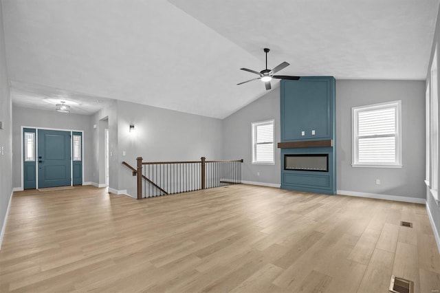 unfurnished living room featuring light hardwood / wood-style floors, vaulted ceiling, and ceiling fan