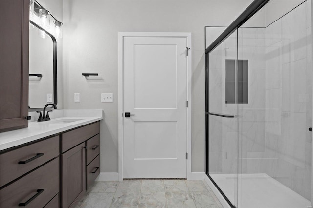 bathroom featuring vanity and a shower with door