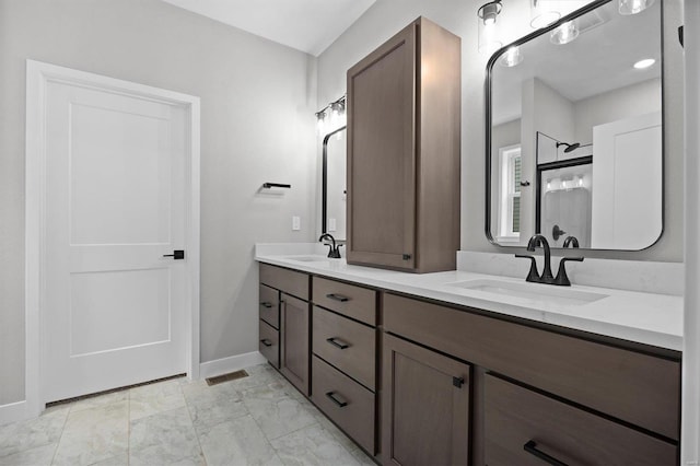 bathroom featuring a shower and vanity