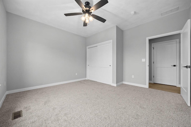 unfurnished bedroom with carpet flooring, a closet, and ceiling fan