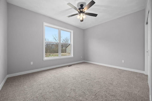 spare room featuring carpet floors and ceiling fan