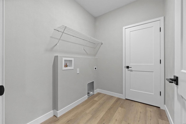 laundry room with hookup for a washing machine, light hardwood / wood-style flooring, and electric dryer hookup