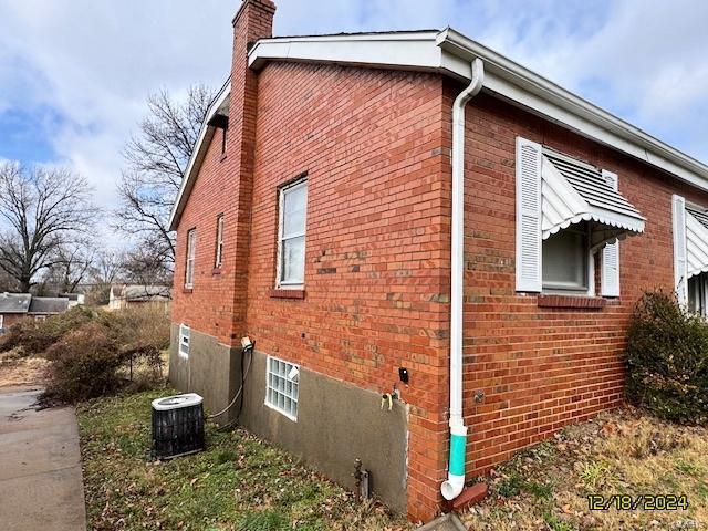 view of side of home with central air condition unit