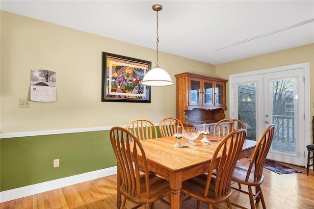 dining space featuring french doors and light hardwood / wood-style floors