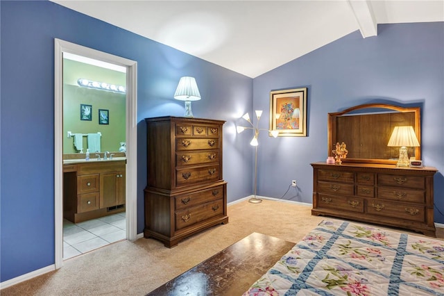 carpeted bedroom featuring connected bathroom and vaulted ceiling with beams