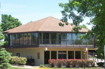 rear view of property featuring a yard