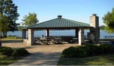 view of home's community with a gazebo and a water view