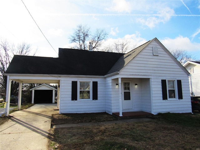 view of front of house featuring a carport, a garage, and an outdoor structure