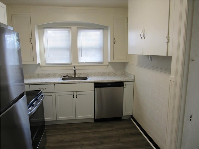 kitchen with dark wood-type flooring, white cabinetry, sink, and stainless steel appliances