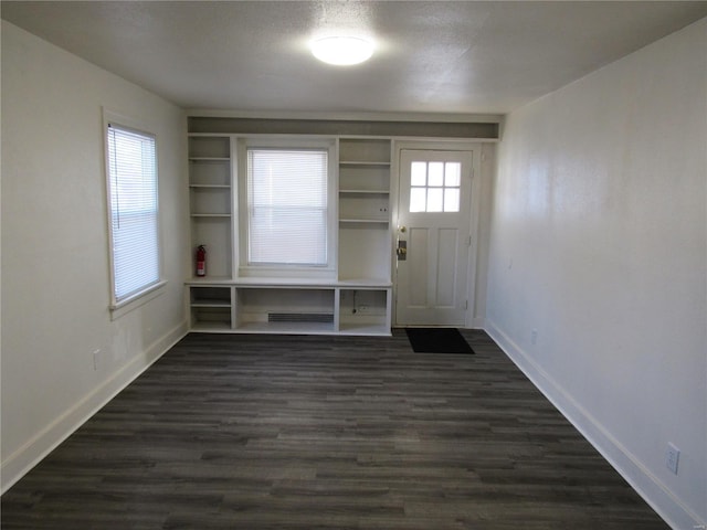 foyer featuring dark hardwood / wood-style flooring and a textured ceiling