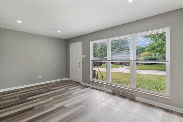 unfurnished room with hardwood / wood-style floors