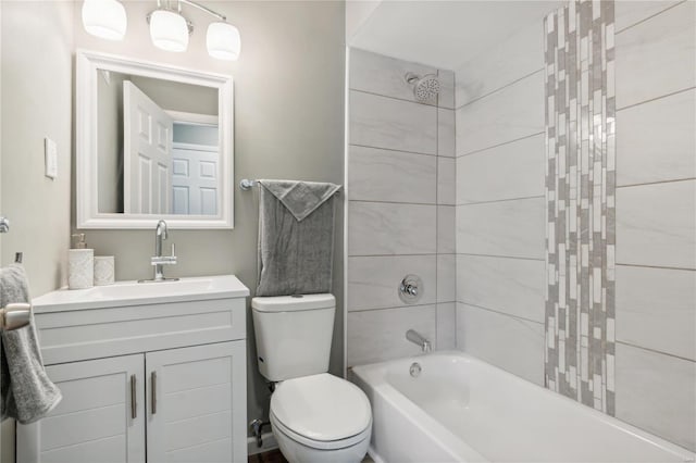 full bathroom featuring vanity, toilet, and tiled shower / bath