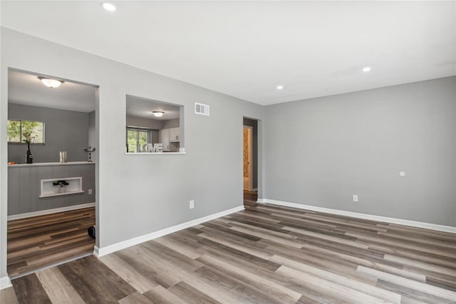 spare room with hardwood / wood-style floors