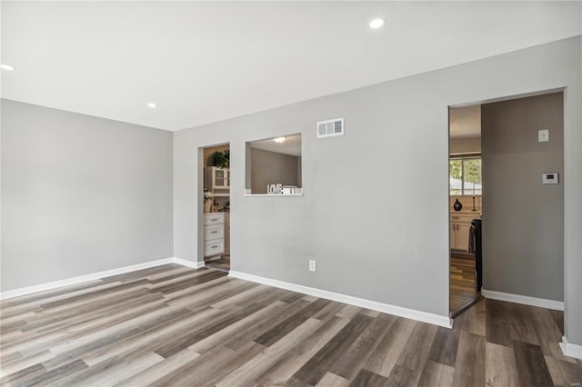 spare room featuring hardwood / wood-style floors