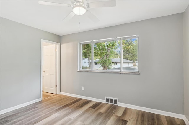 spare room with ceiling fan and wood-type flooring