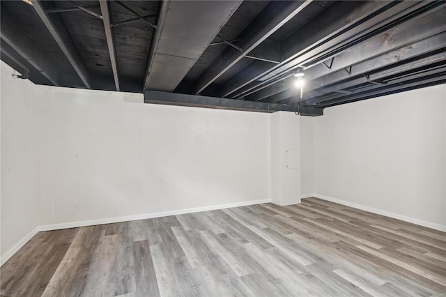 basement with hardwood / wood-style floors