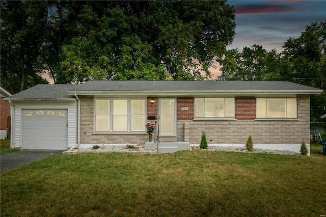 single story home with a lawn and a garage