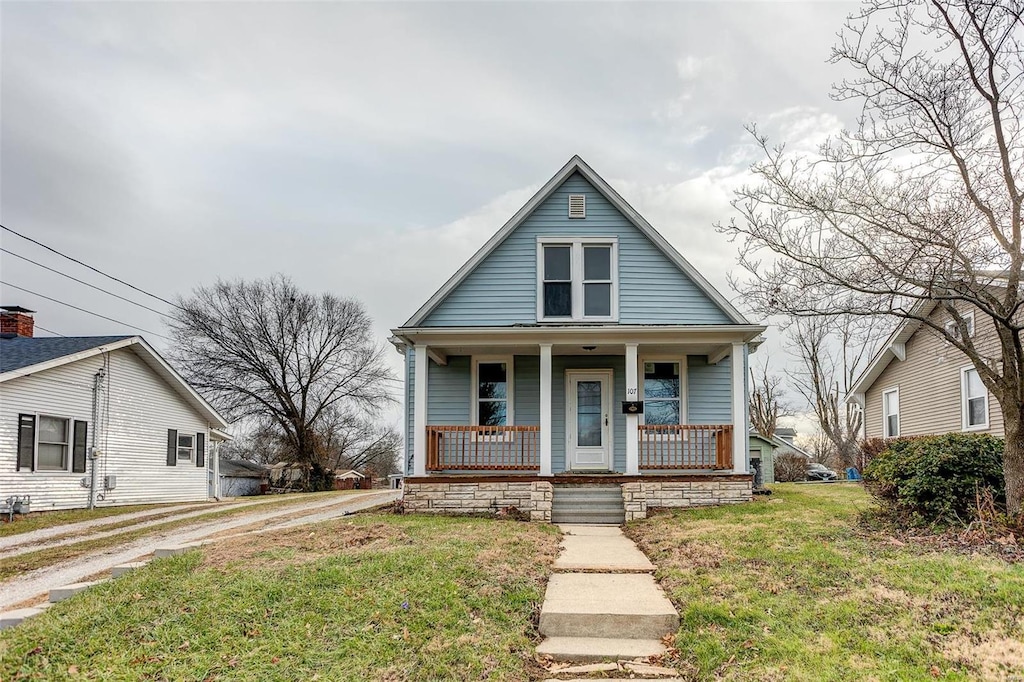 bungalow-style house with a porch and a front lawn