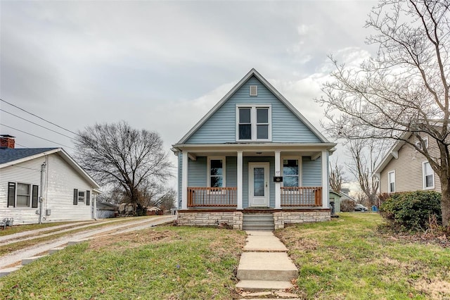 bungalow-style house with a porch and a front lawn