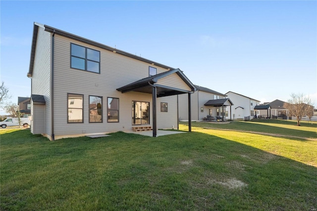 back of property featuring a yard and a patio