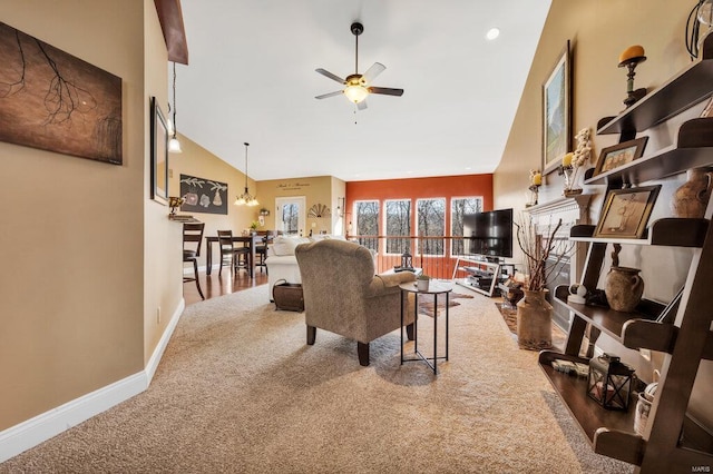 living room featuring carpet, ceiling fan with notable chandelier, and high vaulted ceiling