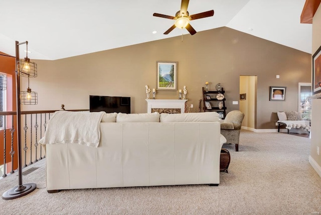 carpeted living room with ceiling fan and vaulted ceiling