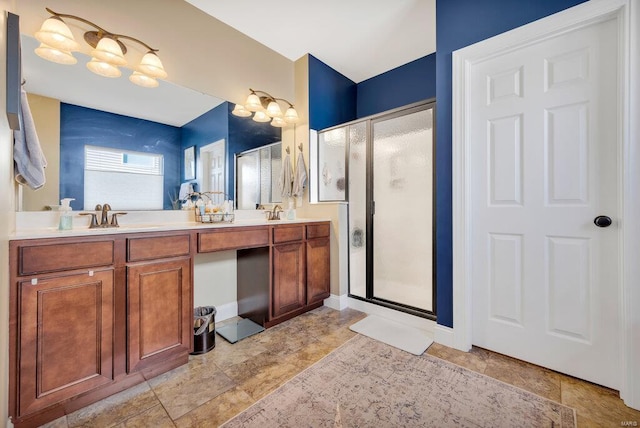 bathroom featuring a shower with shower door and vanity