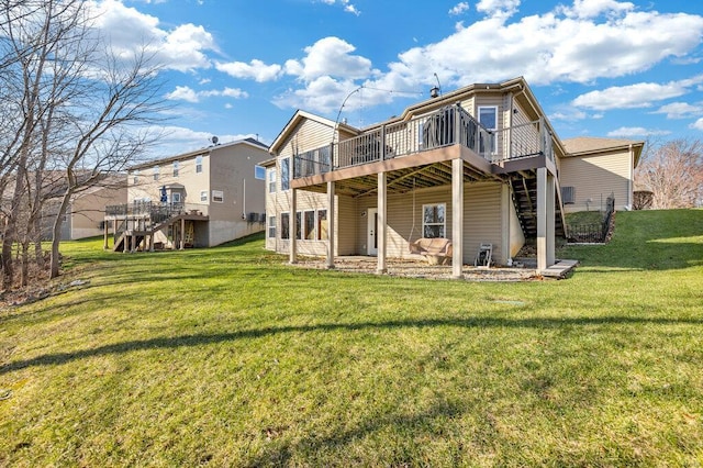 back of house featuring a wooden deck and a yard