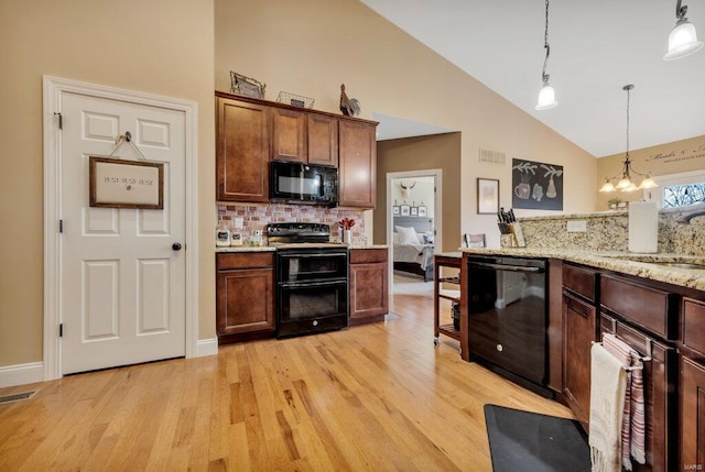 kitchen with black appliances, an inviting chandelier, tasteful backsplash, sink, and hanging light fixtures