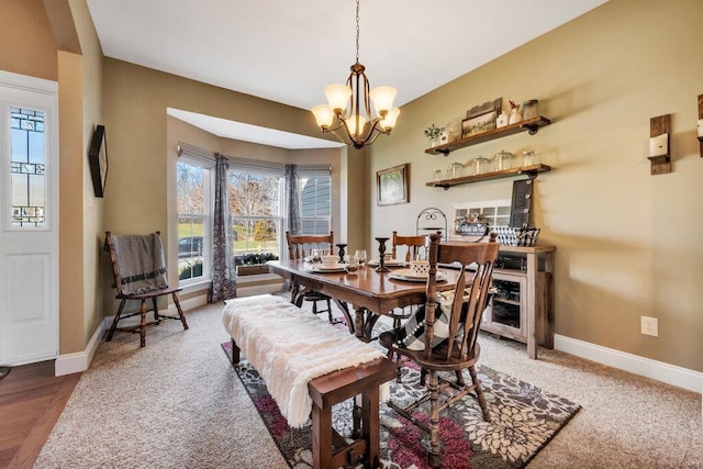 dining area with carpet floors and an inviting chandelier