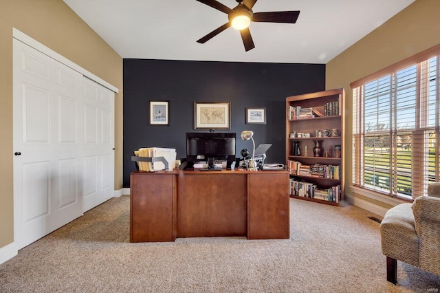 carpeted home office featuring ceiling fan