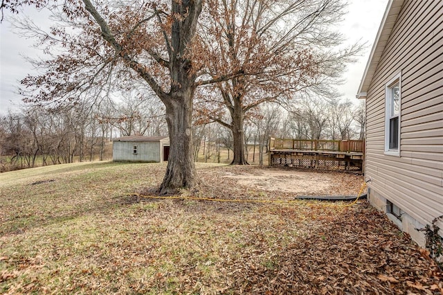 view of yard with a wooden deck and an outdoor structure