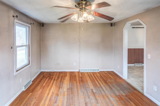 empty room featuring hardwood / wood-style floors, a textured ceiling, and ceiling fan