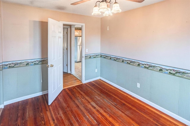 spare room with wood-type flooring and ceiling fan