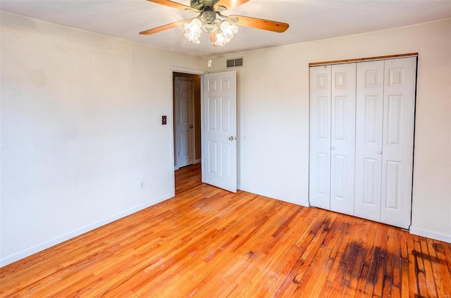 unfurnished bedroom with ceiling fan, a closet, and light hardwood / wood-style floors