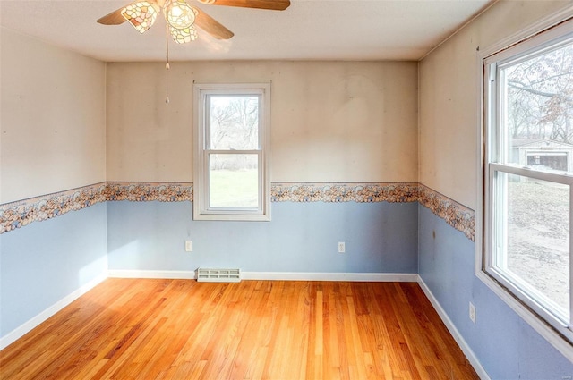 spare room with ceiling fan and hardwood / wood-style floors