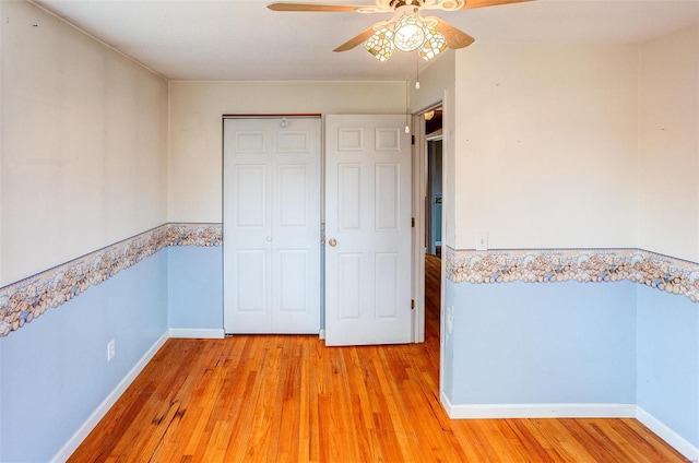 unfurnished bedroom featuring ceiling fan and light wood-type flooring