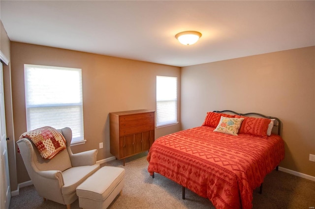 carpeted bedroom featuring baseboards