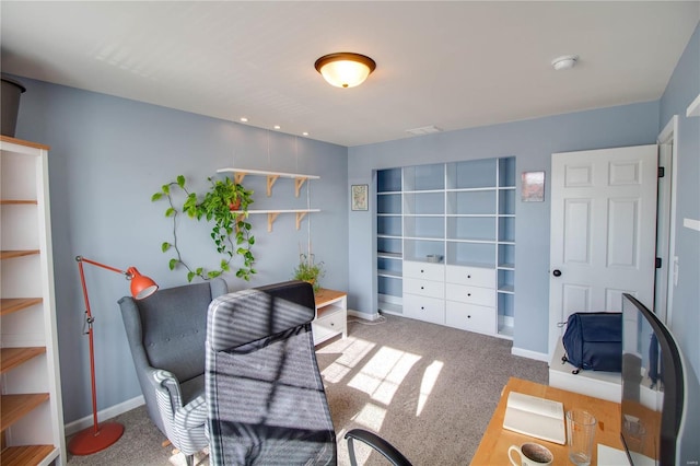 carpeted home office with baseboards