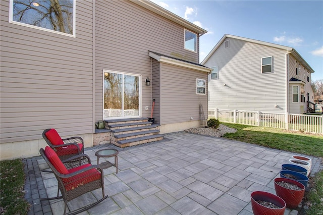 view of patio featuring entry steps and fence