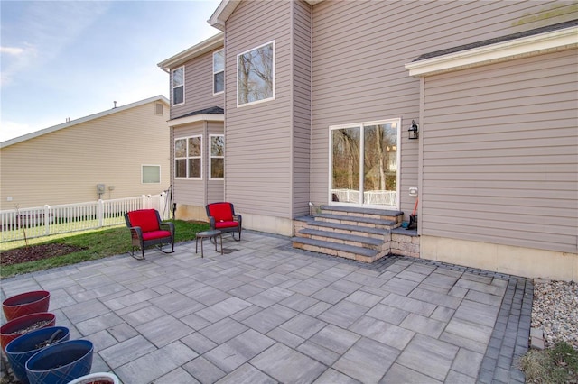 view of patio featuring entry steps and fence