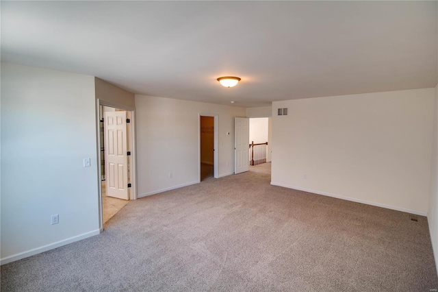 unfurnished room featuring light carpet, baseboards, and visible vents