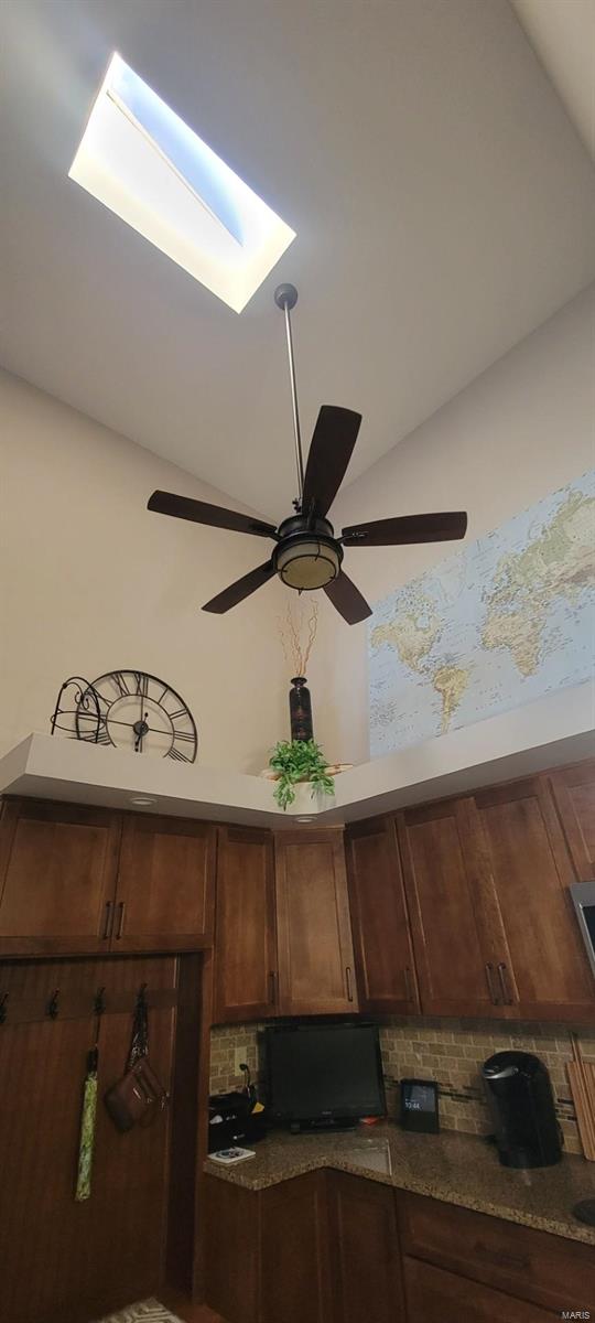 interior details featuring tasteful backsplash and a skylight