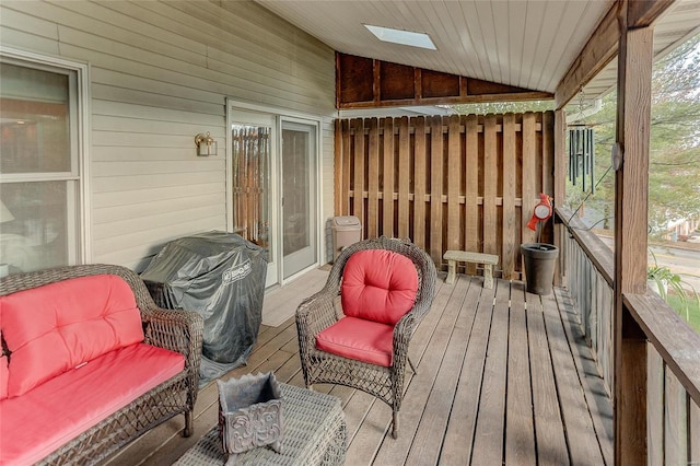 sunroom / solarium with vaulted ceiling with skylight