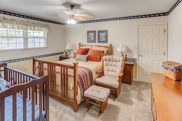 bedroom featuring ceiling fan and light carpet