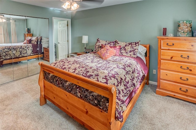 bedroom with ceiling fan, a closet, and light colored carpet