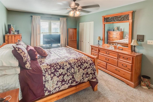 carpeted bedroom featuring ceiling fan and a closet