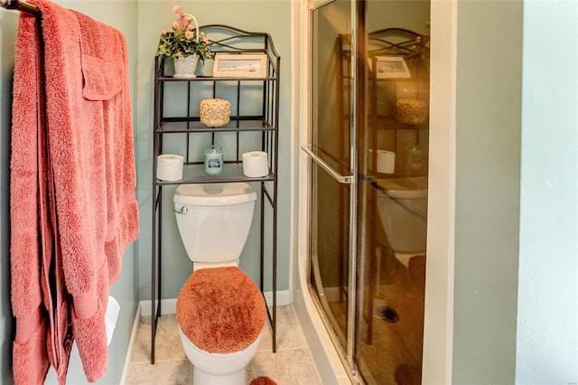 bathroom with tile patterned floors, toilet, and walk in shower