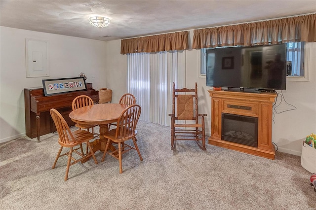 dining space with electric panel and carpet floors